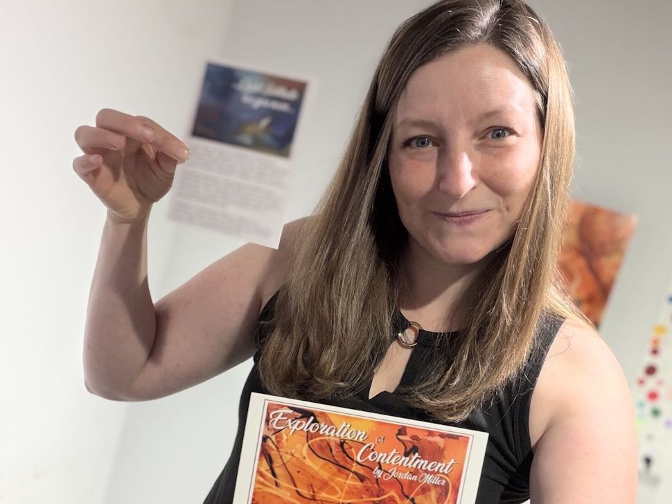 Jordan Miller holds an invitation to her Exploration of Contentment exhibit at Prairie Fusion Arts & Entertainment Centre in Portage la Prairie.
